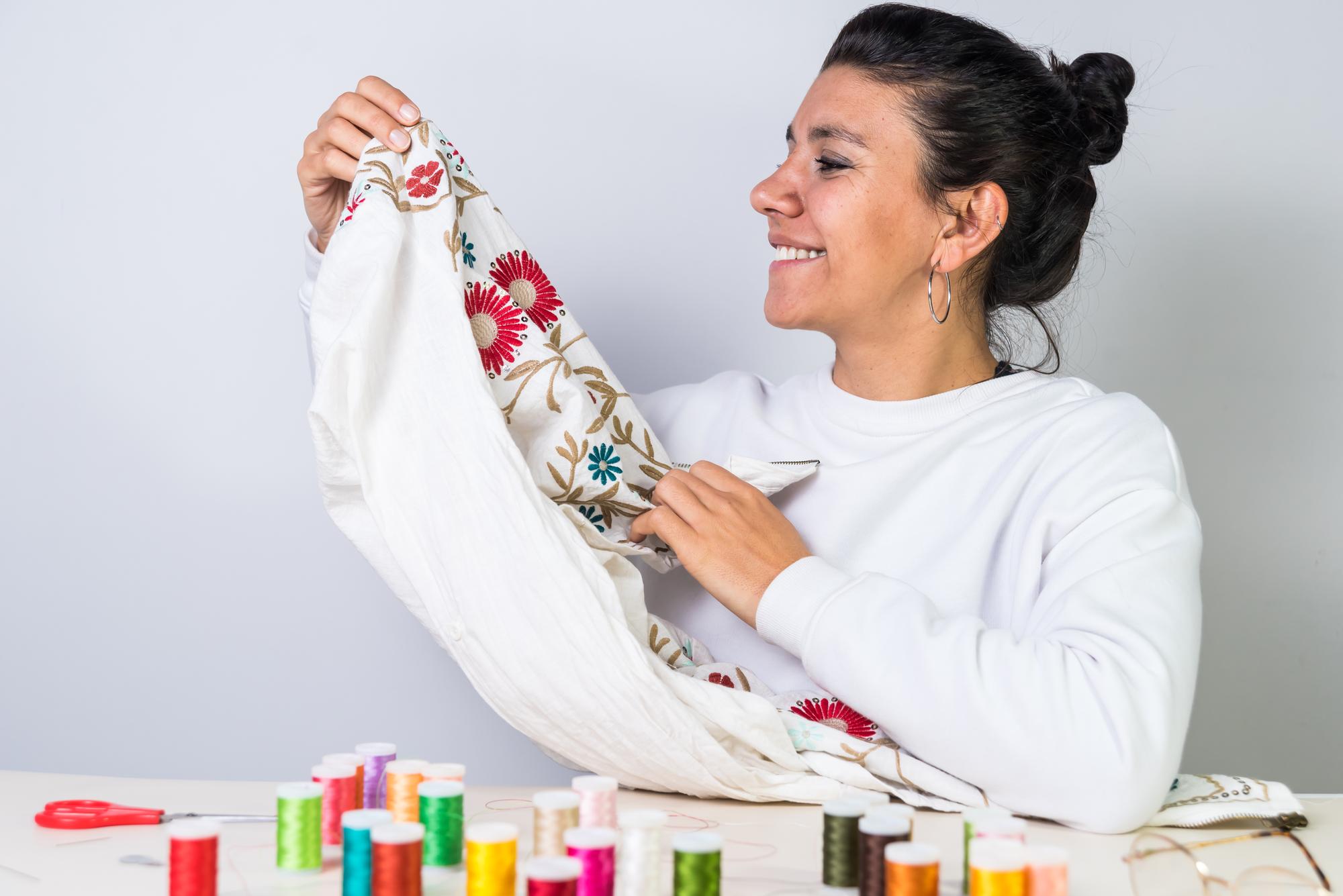 Artist stitching embroidery in bright studio