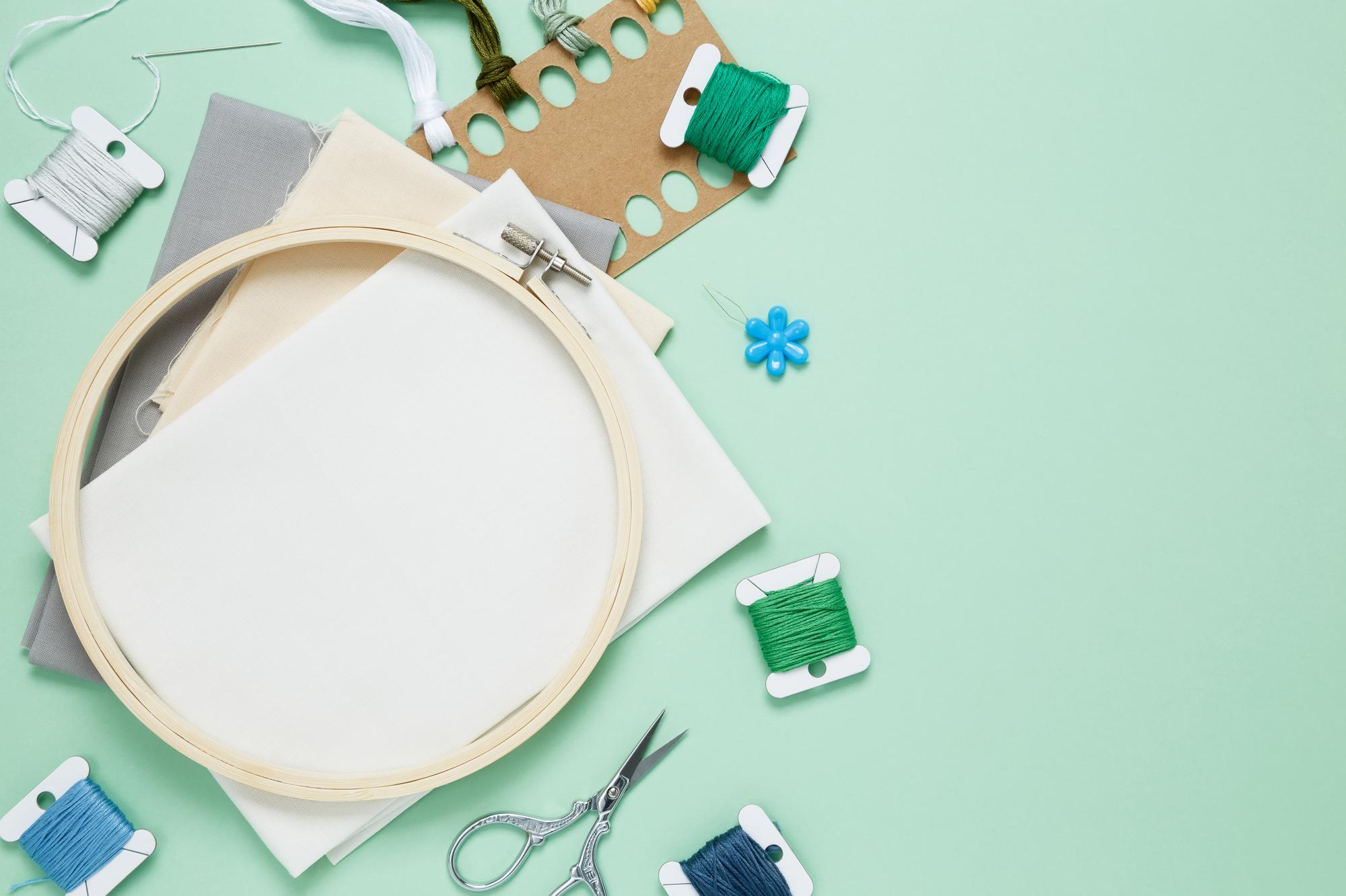 Flatlay of finished embroidered products and tools